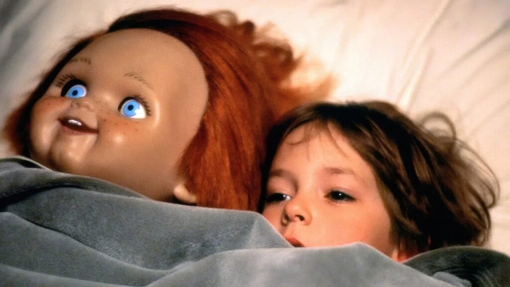 Andy Barclay (Alex Vincent) in bed beside the Good Guy doll in Child's Play (1988)