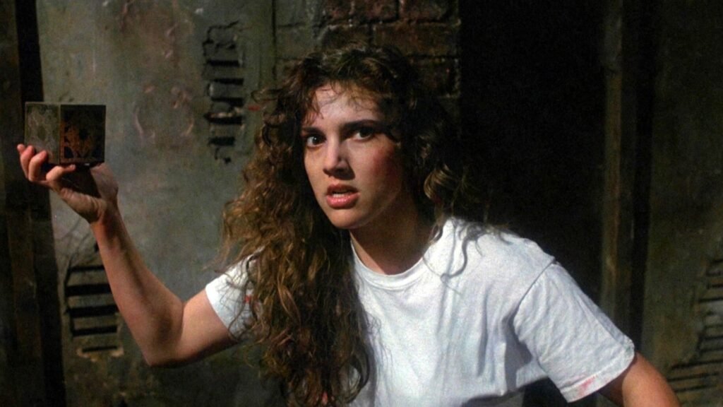 Kirsty Cotton (Ashley Laurence) holding the Lament Configuration puzzle box in Hellraiser (1987)