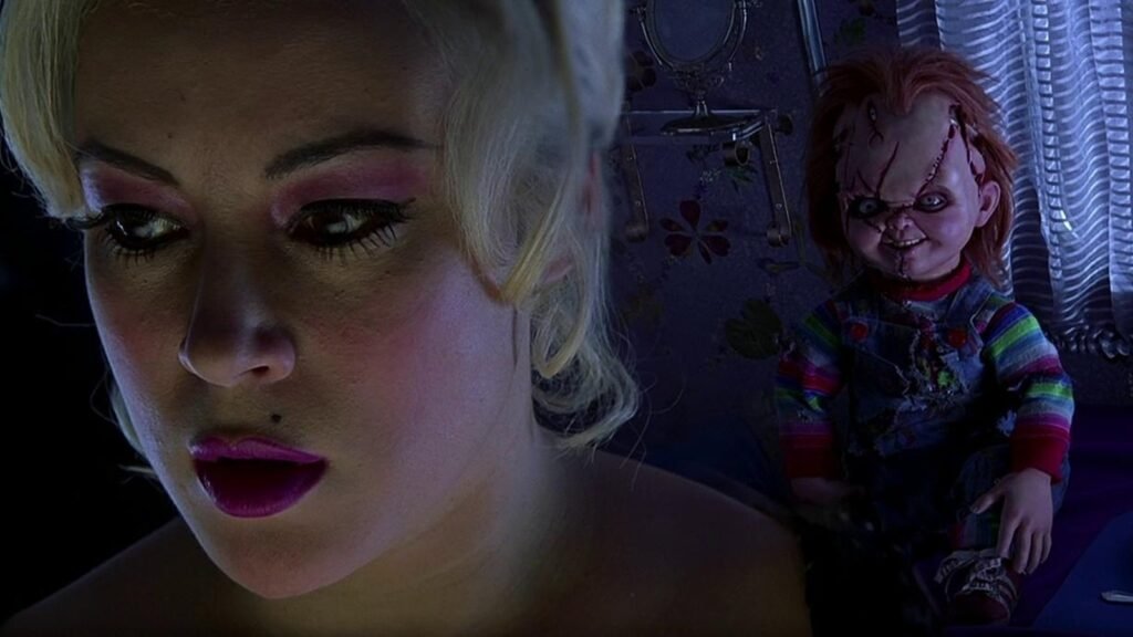 Jennifer Tilly as Tiffany Valentine, with the Chucky doll behind her, in Bride of Chucky (1998)