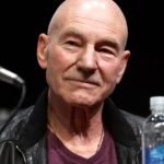 Patrick Stewart smiling at a convention panel — photograph by Gage Skidmore