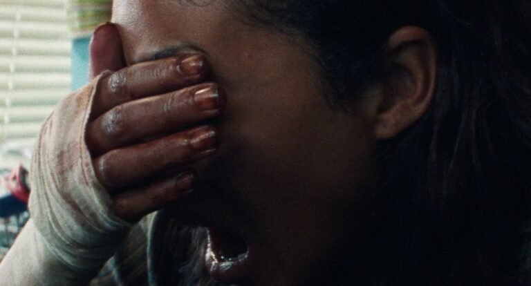 Split Rock production still — a terrified woman screams, hand pressed to her face