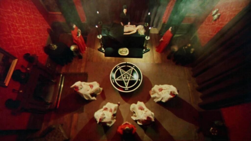 A satanic ritual around a pentagram altar in The Satanic Rites of Dracula (1973)