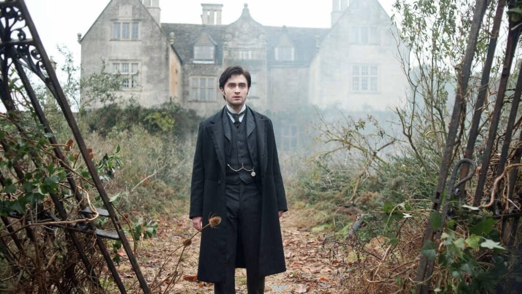 Daniel Radcliffe as Arthur Kipps standing in the grounds of Eel Marsh House in The Woman in Black (2012)